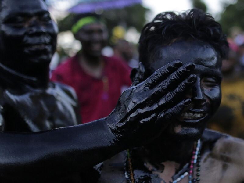 Catholic faithful smeared in burnt oil, take part in the opening of the ten-day celebration of the Santo Domingo de Guzman festival in Managua, on August 1, 2019.  INTI OCON / AFP