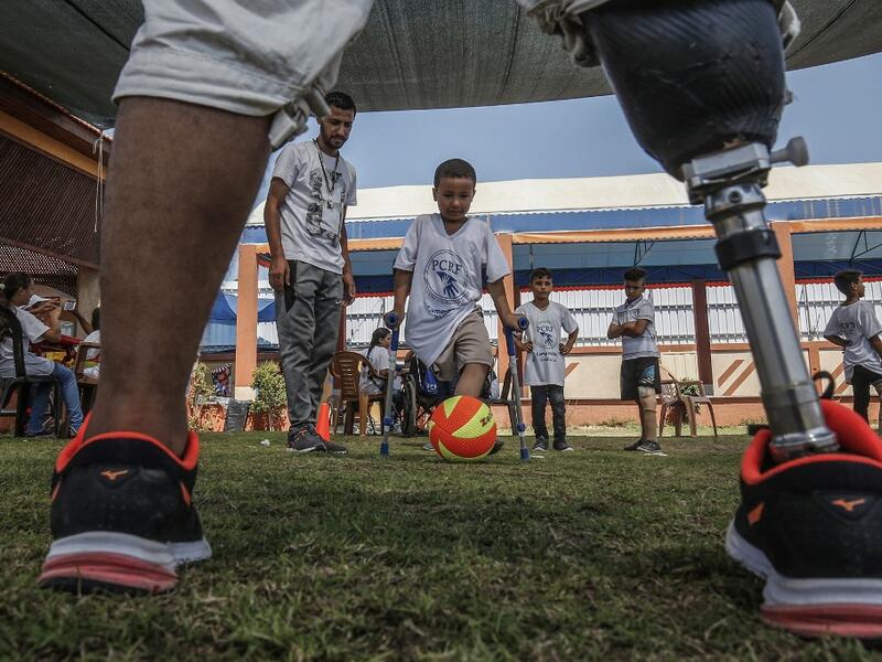 Palestinian amputee children play football during a summer camp origanized by the Palestinian Children's Relief Fund (PCRF) in the town of Khan Yunis in the southern Gaza strip on August 3, 2019.  SAID KHATIB / AFP