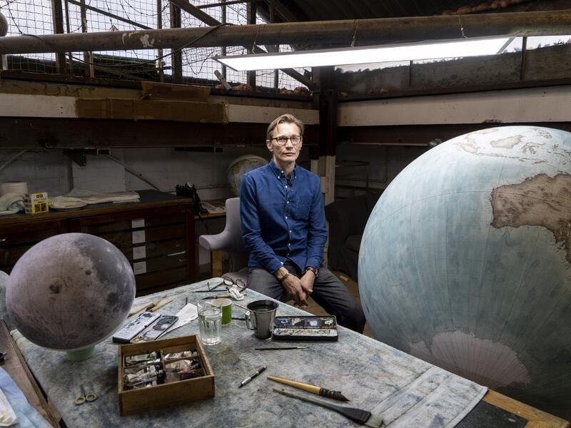 Artisan globemaker, Peter Bellerby poses for a photograph at the Bellerby and Co Globemakers' workshop and headquarters in Stoke Newington in north London, on July 19, 2019. Niklas HALLE'N / AFP