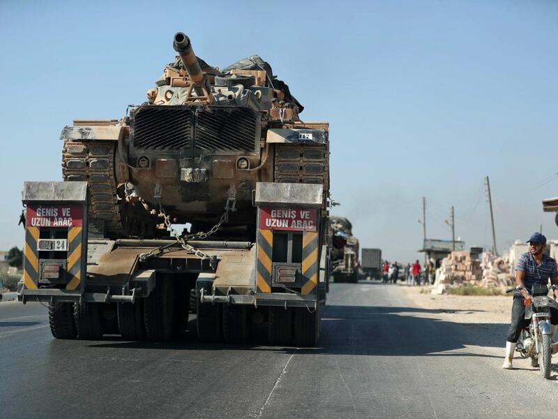 A convoy of Turkish military vehicles passes through the town of Saraqeb in the northwestern province of Idlib reportedly heading toward the town of Khan Sheikhun in the southern countryside of the province on August 19, 2019. (AFP/ File Photo)