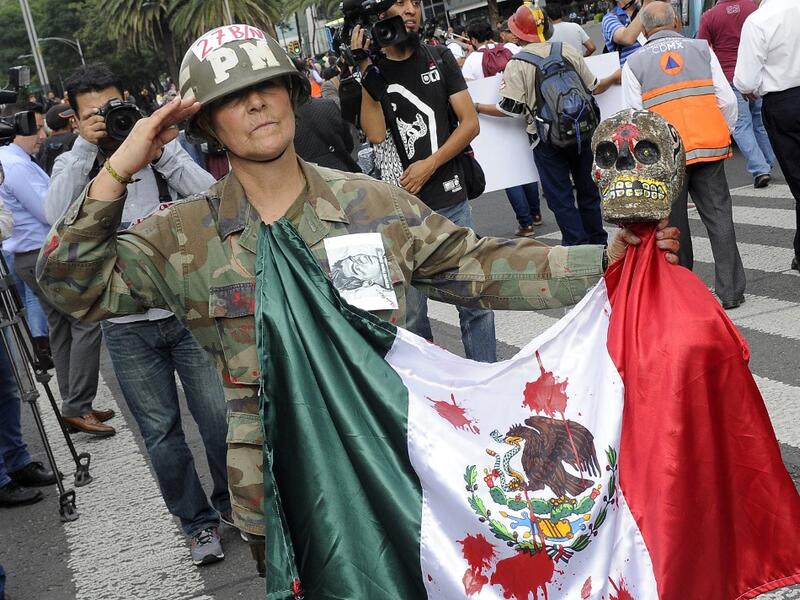  In this file photo taken on September 26, 2016 Mexican activist Julia Klug takes part in a protest in Mexico City, commemorating the second anniversary of the disappearance of the Ayotzinapa students. Pedro Pardo / AFP