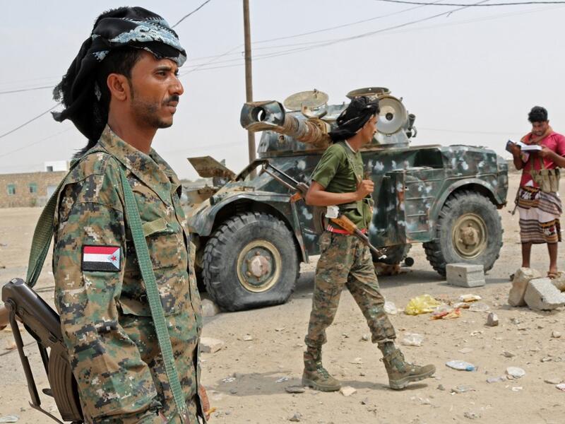 Fighters with the UAE-trained Security Belt Forces loyal to the pro-independence Southern Transitional Council (STC), gather near the south-central coastal city of Zinjibar in south-central Yemen, in the Abyan Governorate, on August 21, 2019. (AFP)