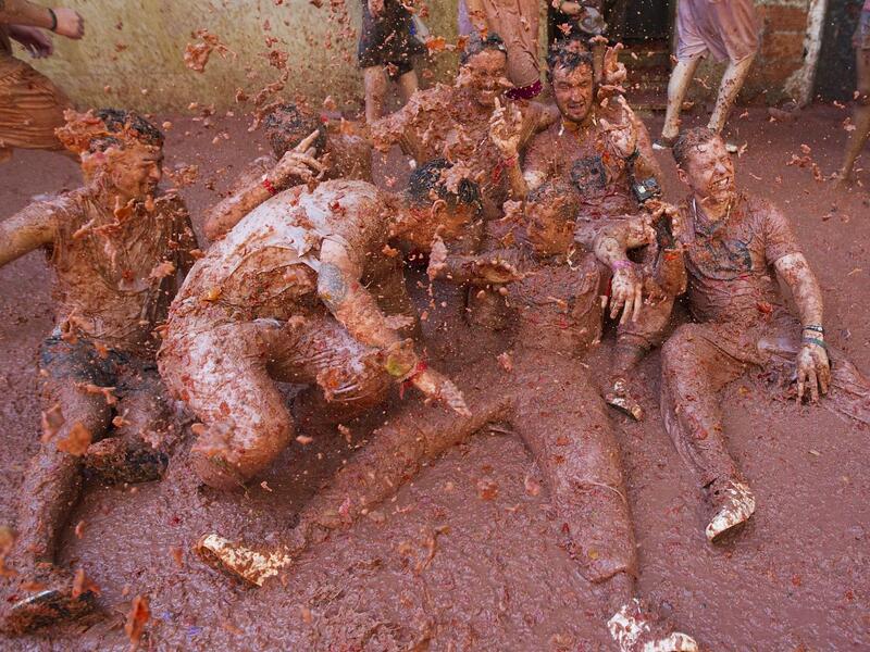 Revellers covered in tomato pulp take part in the annual "Tomatina" festival in the eastern town of Bunol, on August 28, 2019. JAIME REINA / AFP