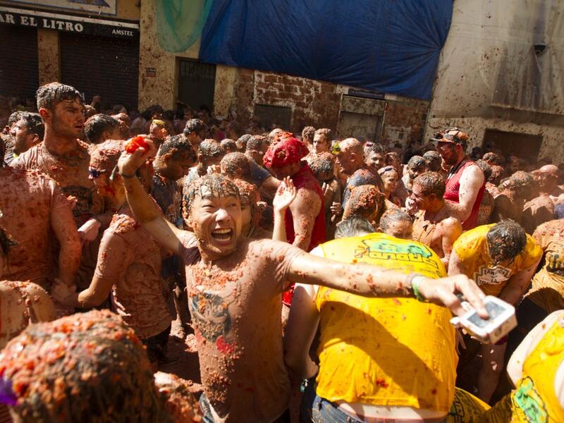 Revellers covered in tomato pulp take part in the annual "Tomatina" festival in the eastern town of Bunol, on August 28, 2019. JAIME REINA / AFP