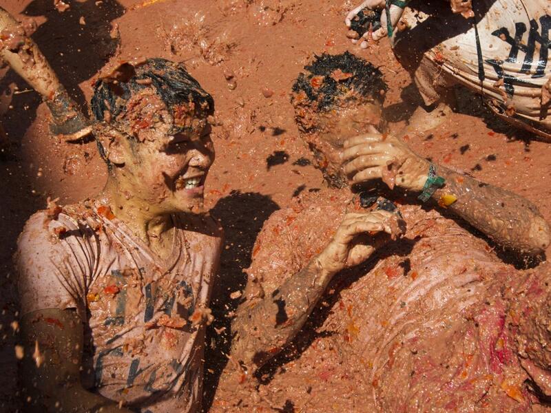 A reveller covered in tomato pulp participates in the annual "Tomatina" festival in the eastern town of Bunol, on August 28, 2019. JAIME REINA / AFP