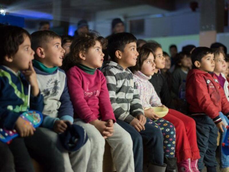 Children attend a film screening as part of the mobile cinema "Komina Film" initiative organised by Syrian-Kurdish filmmaker Shero Hinde, at a school yard in the village of Shaghir Bazar, 55 kilometres southest of Qamishli in the Kurdish-populated areas of northeastern Syria's Hasakeh province, on July 28, 2019. (Twitter)