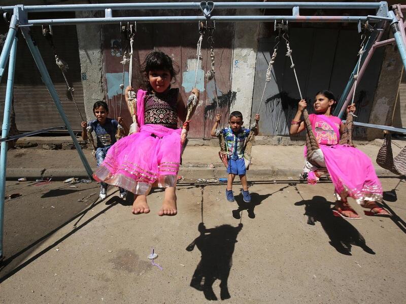 Iraqi children play on a street in Baghdad on the first day of Eid al-Adha. AFP/File Photo