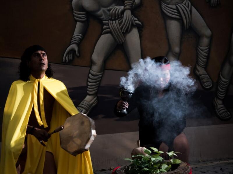 Master Emmanuel Galicia (L) and dancer Beatriz Campos (R) perform ahead of a pre-Columbian ballgame called "Ulama" -in Nahuatl indigenous language- which rule is to hit a "Ulamaloni" (solid rubber ball) with the hip or shoulder, at the FARO Poniente cultural center in Mexico City on August 21, 2019. Omar Torres / AFP