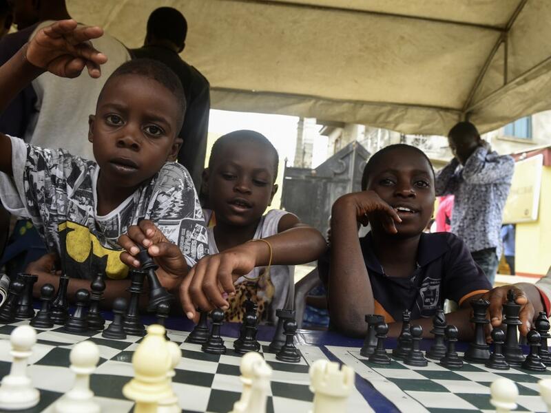 Children sit under a canopy as they play during a chess class at Ogolonto in Ikorodu district of Lagos  PIUS UTOMI EKPEI / AFP
