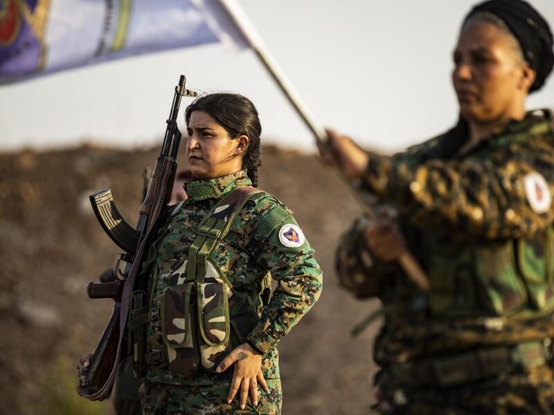Members of the Bethnahrin Women Protection Forces (HSNB), an all-female Syriac-Assyrian paramilitary group under the umbrella of the Syrian Democratic Forces (SDF), line-up as they commemorate the fourth anniversary of their creation, in the countryside of the town of Tall Tamr in the northwestern Syrian province of Hasakah, on August 30, 2019.  Delil SOULEIMAN / AFP