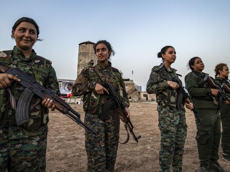 Members of the Bethnahrin Women Protection Forces (HSNB), an all-female Syriac-Assyrian paramilitary group under the umbrella of the Syrian Democratic Forces (SDF), line-up as they commemorate the fourth anniversary of their creation, in the countryside of the town of Tall Tamr in the northwestern Syrian province of Hasakah, on August 30, 2019.  Delil SOULEIMAN / AFP