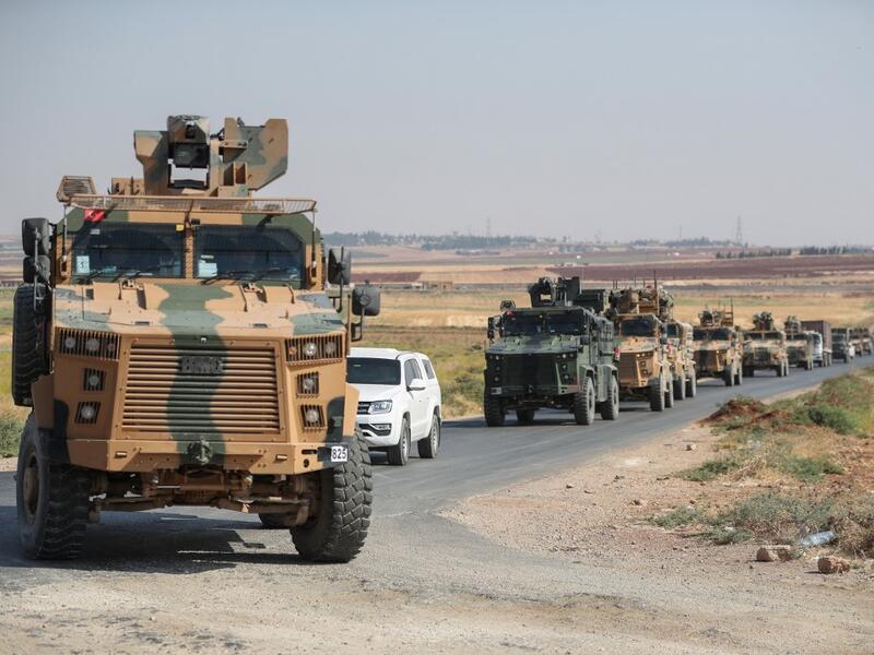 A picture taken on September 1, 2019 shows a convoy of Turkish military vehicles passing through the village of Kafr Halab on the western edge of Aleppo province.  (Omar HAJ KADOUR / AFP)