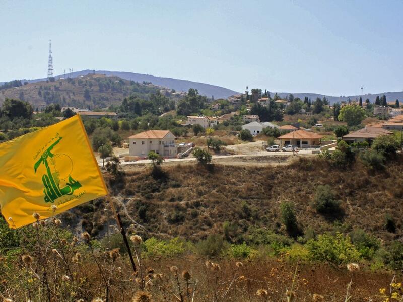 A Hezbolla flag flutters in the Khiyam plain on the Lebanese side of the border with Israel   (AFP) A Hezbolla flag flutters in the Khiyam plain on the Lebanese side of the border with Israel   (AFP)