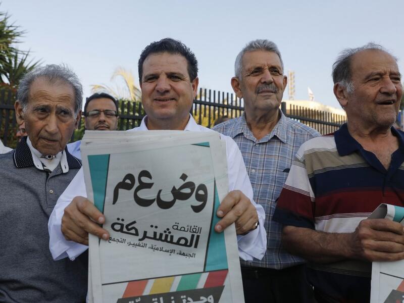 Ayman Odeh, head of the Arab Joint List alliance, holds his pamphlets during a campaign rally in the Arab Israeli city of Tira, north of Tel Aviv, on September 5, 2019 . AHMAD GHARABLI / AFP