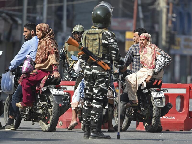 Indian paramilitary troopers stop Indian Kashmiri motorcyclists during a strict curfew in Lal Chowk (AFP) Indian paramilitary troopers stop Indian Kashmiri motorcyclists during a strict curfew in Lal Chowk (AFP)
