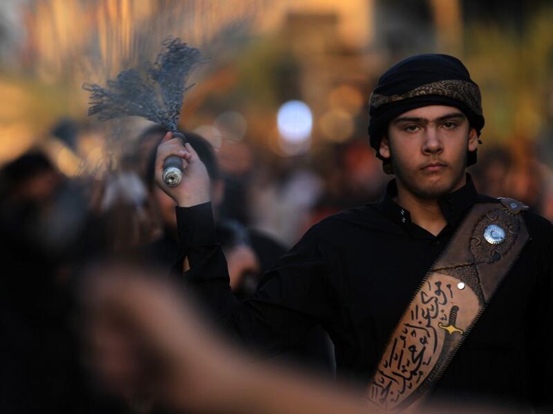 Iraqi Shiite men beat their backs with metal chains in the capital Baghdad's mostly Shiite neighbourhood of Kadhimiya marking the 8th day of Muharram, ahead of Ashura. Ahmad AL-RUBAYE / AFP