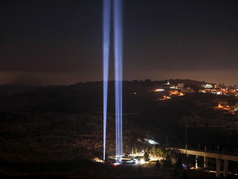 This picture shows a light show in tribute to New York City's World Trade Centre Twin Towers on the eve of the 18th anniversary of the September 11, 2001 terror attacks, at the 9/11 Living Memorial Plaza on a hill overlooking Jerusalem. AHMAD GHARABLI / AFP