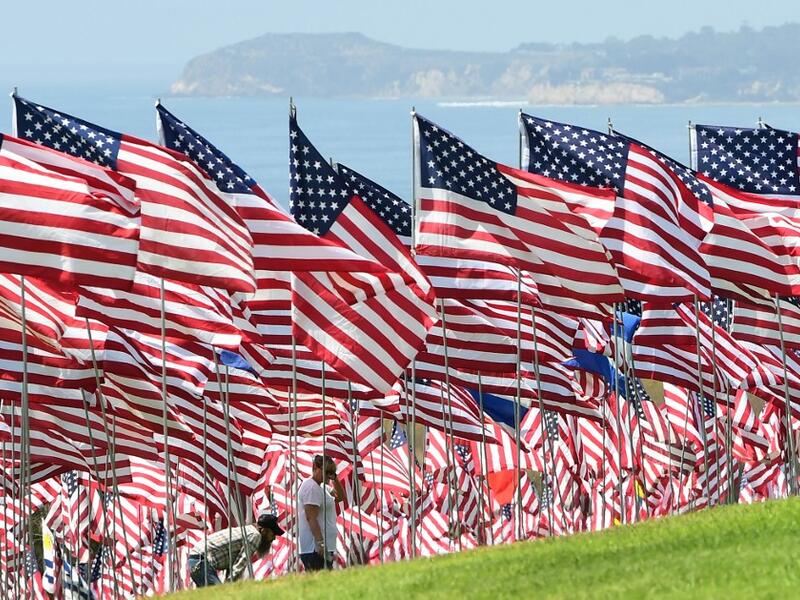 People visit the Pepperdine Wave of Flags display at Pepperdine University in Malibu, California, commemorating those who died in the September 11, 2001 attacks with 2,977 flags. Frederic J. BROWN / AFP