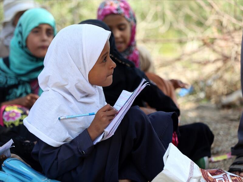 School children attend an open-air class under a tree near their unfinished school in the southwestern Yemeni village of al-Kashar in Taez governorate's Mashraa and Hadnan district at the start of the new academic year in the war-battered country.  Ahmad AL-BASHA / AFP