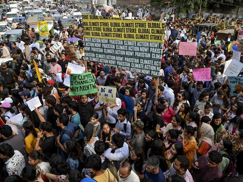 Youths hold placards as they march for a climate strike to protest against governmental inaction towards climate breakdown and environmental pollution, part of demonstrations being held worldwide in a movement dubbed "Fridays for Future", in Lahore on September 20, 2019. ARIF ALI / AFP