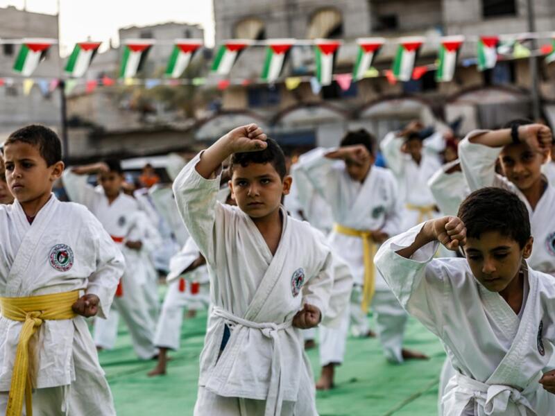 Young Palestinian karatekas demonstrate their skills during a Karate promotion ceremony at a sporting centre in the Rafah camp for Palestinian refugees in the southern Gaza Strip on September 20, 2019. SAID KHATIB / AFP