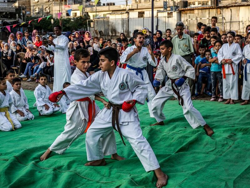 Young Palestinian karatekas demonstrate their skills during a Karate promotion ceremony at a sporting centre in the Rafah camp for Palestinian refugees in the southern Gaza Strip on September 20, 2019. SAID KHATIB / AFP