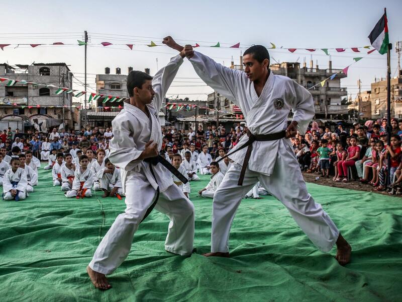 Young Palestinian karatekas demonstrate their skills during a Karate promotion ceremony at a sporting centre in the Rafah camp for Palestinian refugees in the southern Gaza Strip on September 20, 2019. SAID KHATIB / AFP