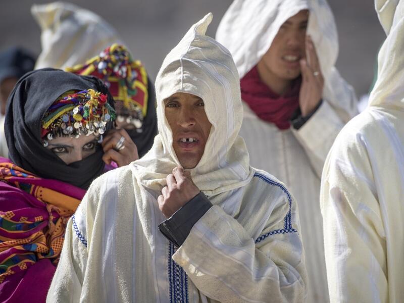Young Amazigh (Berber) men and women wait for their wedding ceremony during the annual "Engagement Moussem" festival near the village of Imilchil in central Morocco's high Atlas Mountains on September 21, 2019. Each year in the High Atlas Mountains hamlet of Ait Amer, tribes celebrate with dances and music, the collective wedding of young Amazigh couples during the traditional festival of "Engagement Moussem". FADEL SENNA / AFP