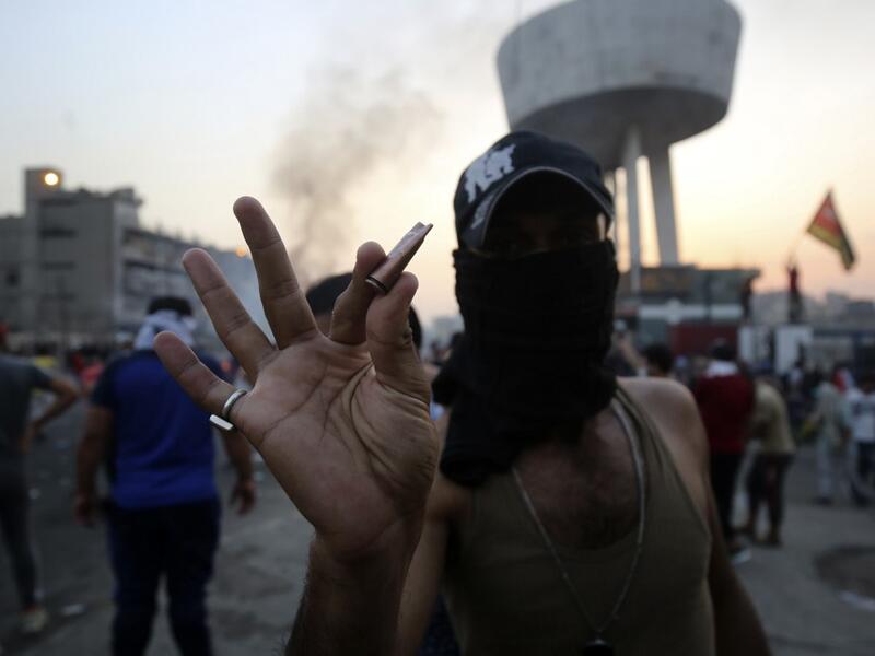 An Iraqi protester displays bullet casings during a demonstration against state corruption, failing public services and unemployment at Tayaran square in Baghdad on October 2, 2019. Iraq's president and the United Nations urged security forces to show restraint after two protesters were killed in clashes with police that other top officials blamed on "infiltrators." AHMAD AL-RUBAYE / AFP