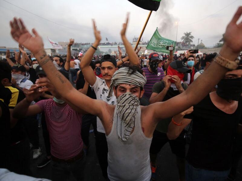 Iraqi protesters chant slogans during a demonstration against state corruption, failing public services and unemployment at Tayaran square in Baghdad on October 2, 2019. Iraq's president and the United Nations urged security forces to show restraint after two protesters were killed in clashes with police that other top officials blamed on "infiltrators." AHMAD AL-RUBAYE / AFP