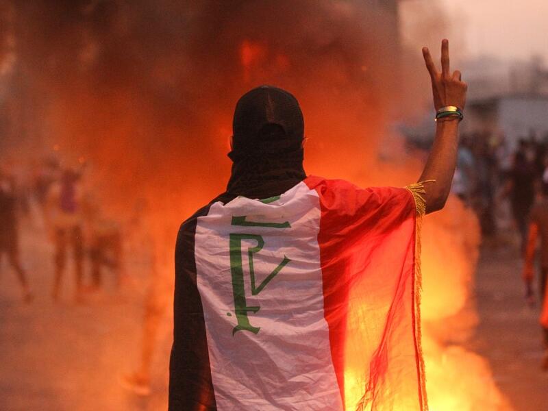 An Iraqi protester gestures the v-sign during a demonstration against state corruption, failing public services and unemployment at Tayaran square in Baghdad on October 2, 2019. (AFP/ File Photo)