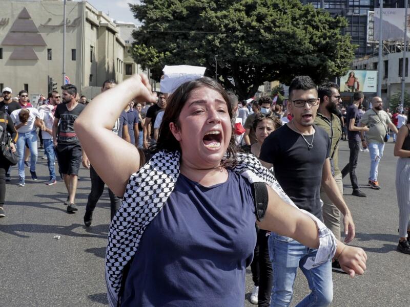 A Lebanese protester shouts slogans during a demonstration near central Beirut's Martyr Square on October 6, 2019. Lebanese protested in the capital over increasingly difficult living conditions, amid fears of a dollar shortage and possible price hikes. ANWAR AMRO / AFP