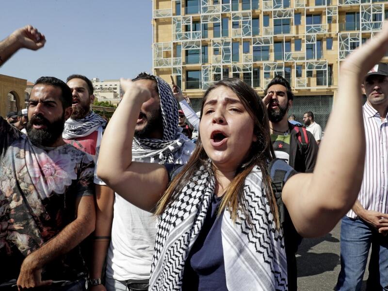 Lebanese protesters chants slogans during a demonstration in central Beirut's Martyr Square on October 6, 2019. Lebanese protested in the capital over increasingly difficult living conditions, amid fears of a dollar shortage and possible price hikes. ANWAR AMRO / AFP