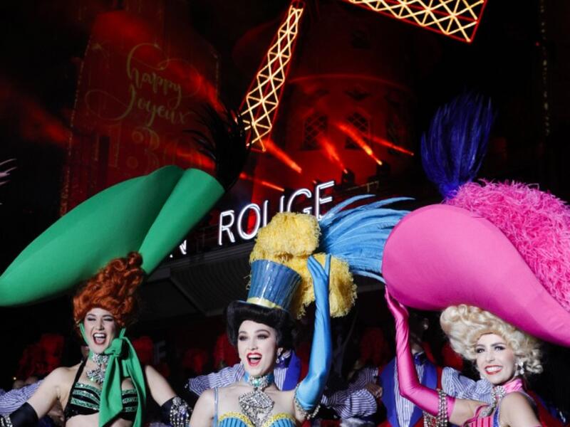 Moulin Rouge dancers pose during the celebration of the 130th anniversary of the French oldest cabaret, on October 6, 2019 in Paris.  GEOFFROY VAN DER HASSELT / AFP