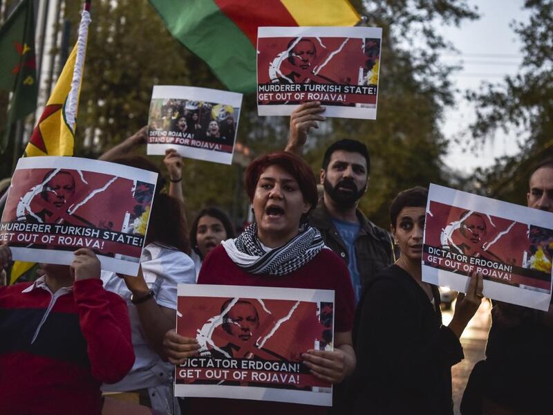 Kurds living in Athens hold banners as they protest near the Turkish embassy in Athens, on October 9, 2019. Turkey launched an assault on Kurdish forces in northern Syria with air strikes and explosions reported along the border. President Recep Tayyip Erdogan announced the start of the attack on Twitter, labelling it "Operation Peace Spring". Louisa GOULIAMAKI / AFP