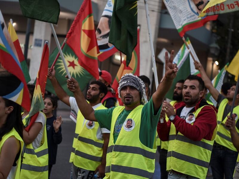 Kurds living in Athens hold flags during a protest near the Turkish embassy in Athens, on October 9, 2019. Louisa GOULIAMAKI / AFP