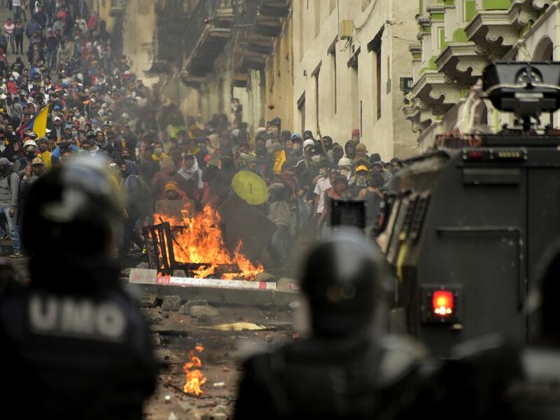 Demonstrators clash with riot police in Quito on October 9, 2019, on the second day of violent protests over a fuel price hike ordered by the government to secure an IMF loan. The violence broke out as thousands of people representing indigenous groups, farmers and labour unions marched on a square in downtown Quito near the government headquarters demanding that Moreno reinstate fuel subsidies. RODRIGO BUENDIA / AFP