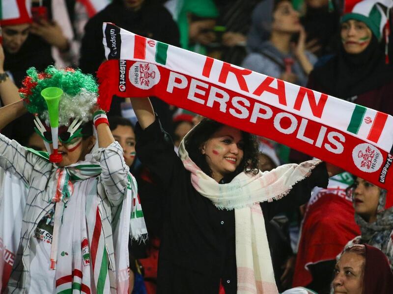 The Islamic republic has barred female spectators from football and other stadiums for around 40 years, with clerics arguing they must be shielded from the masculine atmosphere and sight of semi-clad men. Women fans are attending the football match freely for the first time in decades, after FIFA threatened to suspend the country over its controversial male-only policy.  ATTA KENARE / AFP