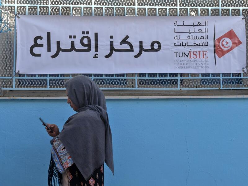 A Tunisian voter waits outside a polling station in the capital Tunis on October 13, 2019 during the second round of the presidential election. Tunisians began voting today in a presidential runoff pitting conservative law professor Kais Saied against media magnate Nabil Karoui, who was released from prison just days earlier. Fethi Belaid / AFP