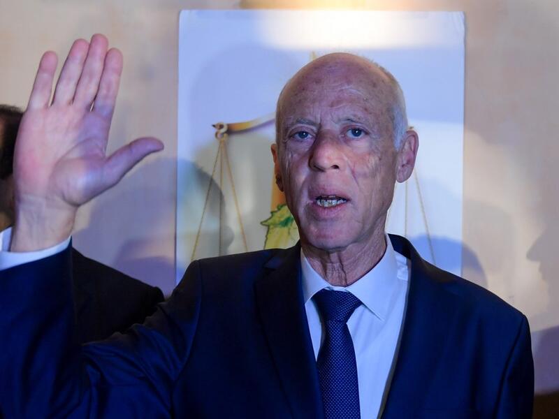 Conservative academic Kais Saied celebrates his victory in the Tunisian presidential election in the capital Tunis on October 13, 2019. Saied won a landslide victory in Tunisia's presidential runoff, sweeping aside his rival, media magnate Nabil Karoui, state television Wataniya said. It said he scooped almost 77 percent of the vote, compared to 23 percent for Karoui. Fethi Belaid / AFP