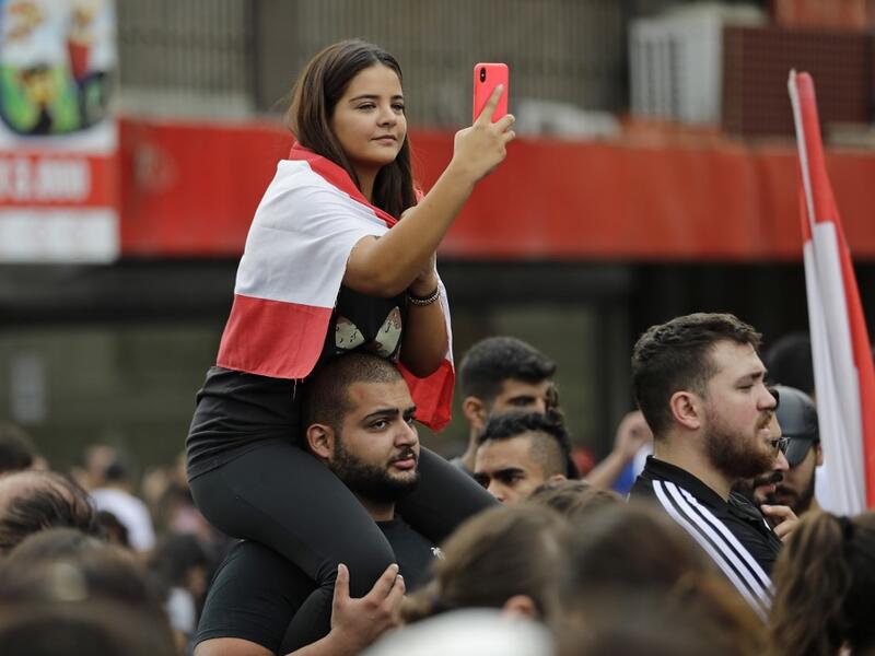 Lebanese demonstrators gather during a protest against dire economic conditions in Zouk Mikael, north of the Lebanese capital Beirut, on October 18, 2019. Public anger has simmered since parliament passed an austerity budget in July to help trim a ballooning deficit and flared on Thursday over new plans to tax calls on messaging applications such as Whatsapp, forcing the government to axe the unpopular proposal. JOSEPH EID / AFP