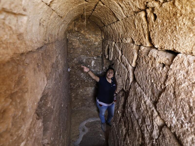 Timnah Goloubin, an archaeologist with the Israel Antiquities Authority, shows on October 23 2019 the ancient church crypt in the Israeli town of Bet Shemesh. A magnificent 1500-year-old church, decorated with spectacular mosaic floors and Greek inscriptions, was discovered during a three-year excavation near a residential area. MENAHEM KAHANA / afp