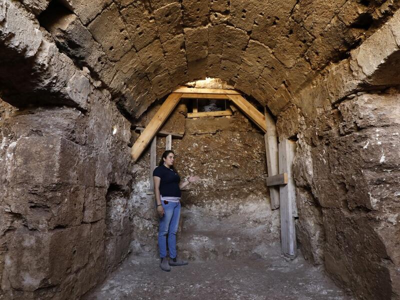 Timnah Goloubin, an archaeologist with the Israel Antiquities Authority, shows on October 23, 2019 the ancient church crypt in the Israeli city of Bet Shemesh. A magnificent 1500-year-old church, decorated with spectacular mosaic floors and Greek inscriptions, was discovered during a three-year excavation near a residential area. MENAHEM KAHANA / afp