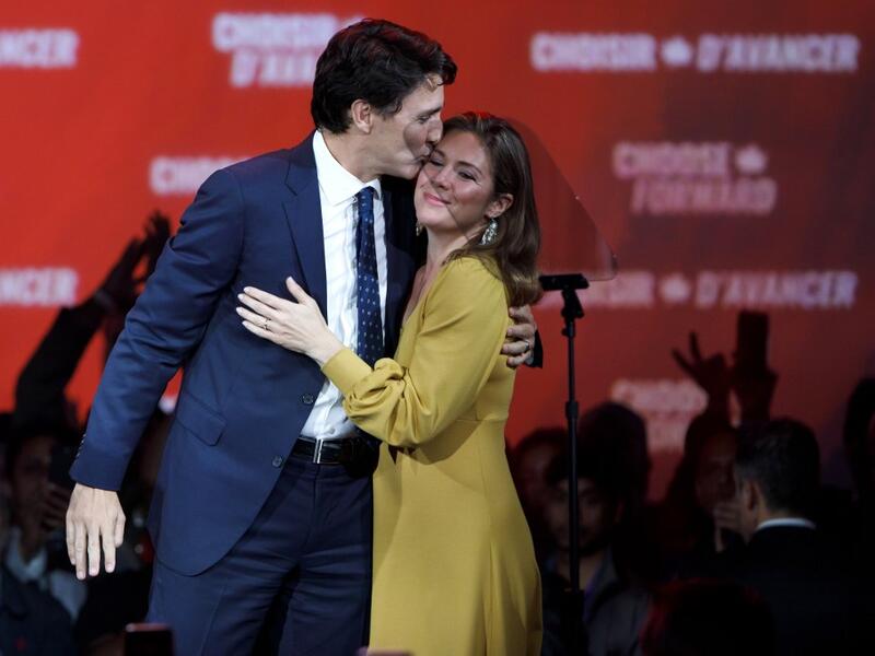 Liberal Leader and Canadian Prime Minister Justin Trudeau kisses his wife Sophie Grégoire Trudeau after delivering his victory speech at his election night headquarters  (AFP)