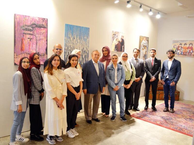 Saudi Arabia’s permanent representative to the UN Abdallah Al-Mouallimi, center, with the exhibition’s volunteers and guests on the opening day. (Photo/Supplied/ Arab News))