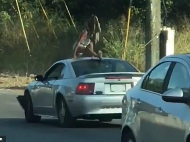 Myscellent Shelton-Cox, 23, was arrested and charged with disorderly conduct early Friday morning for dancing on the roof of a Mustang during slow-moving traffic. (Video Screenshot)