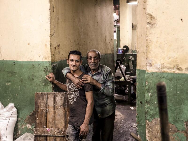 Egyptian confectioners pose for a picture at a candy factory in the capital Cairo on November 2, 2019, ahead of celebrations of the Muslim Prophet Mohammed's birthday, known as "Al Mawlid Al Nabawi". Prophet Mohamed was born in Saudi Arabia's arid mountainous city of Mecca, the holiest in Islam, some 1490 years ago. Sunni Muslims in many parts of the world celebrate his birthday on the 12th day of the third month of the Islamic calendar, which will fall this year on November 9th.  Mohamed el-Shahed / AFP