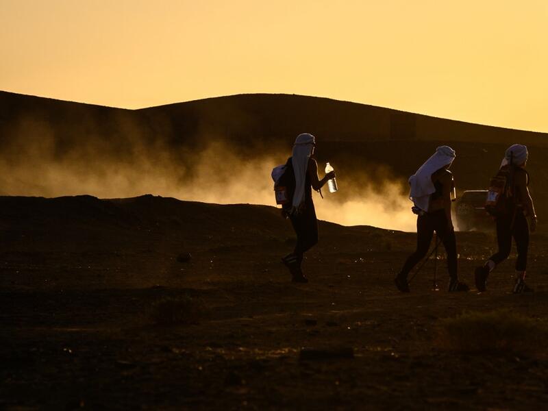 Women take part in the desert trek "Rose Trip Maroc", on November 3, 2019 in the erg Chebbi near Merzouga. The Rose Trip Maroc is a female-oriented trek where teams of three must travel through the southern Moroccan Sahara desert with a compass, a map and a topographical reporter. JEAN-PHILIPPE KSIAZEK / AFP