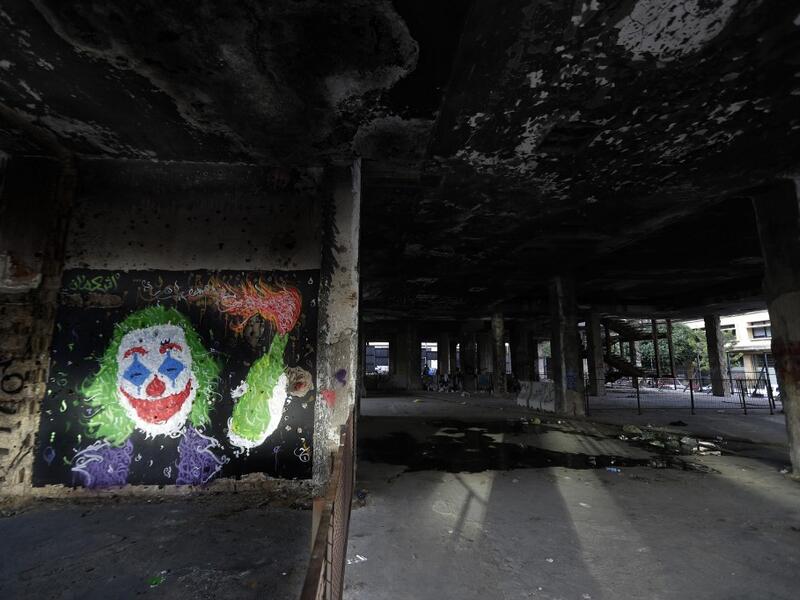 A graffiti by street artist Ashekman is sprayed inside "the Egg" building in Lebanon's capital Beirut on November 11, 2019. Since October 17, the chanting of tens of thousands of Lebanese denouncing the political elite have shaken the normally staid district around two Beirut squares, Martyrs' and Riad Al Solh. JOSEPH EID / AFP