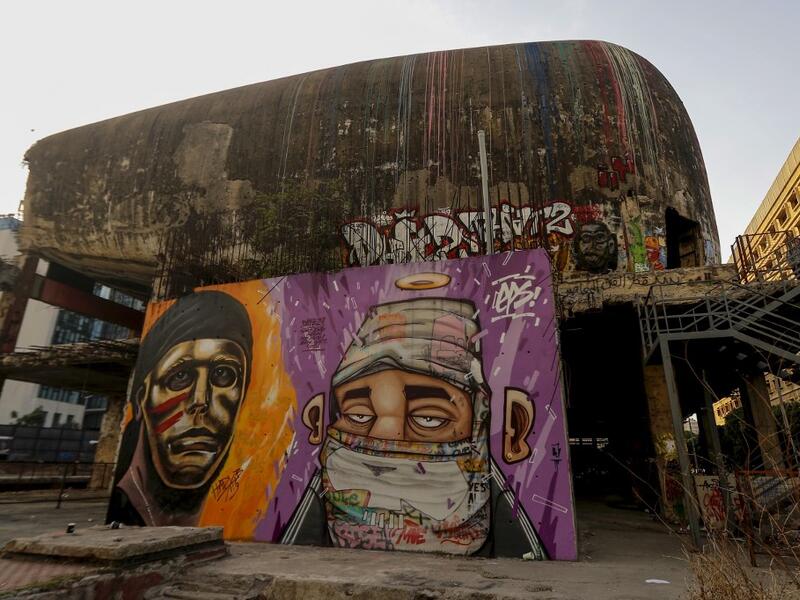 Graffitis are sprayed on a wall in front of "the Egg" building in Lebanon's capital Beirut on November 11, 2019. Since October 17, the chanting of tens of thousands of Lebanese denouncing the political elite have shaken the normally staid district around two Beirut squares, Martyrs' and Riad Al Solh. JOSEPH EID / AFP